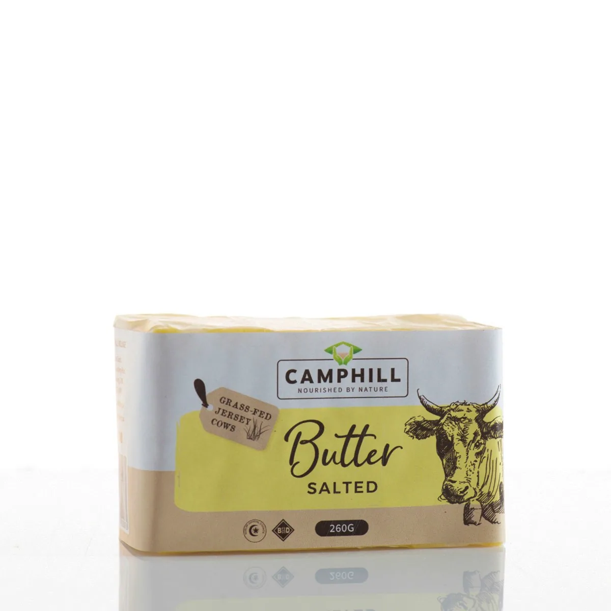 A wrapped block of Camphill salted butter, its paper printed with a cow illustration